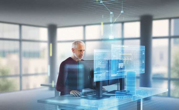 Man facing 2 monitors with other virtual monitor showing desigo cc for building management system