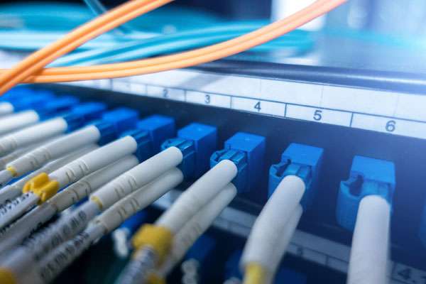 blue fiber cable connected in a fiber box arranged neatly with structured cabling in mind